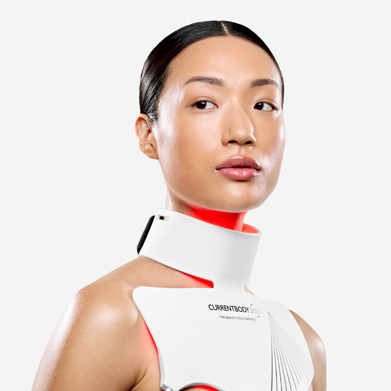 Woman using CurrentBody LED Neck & Décolletage Mask Series 2 on her neck and chest