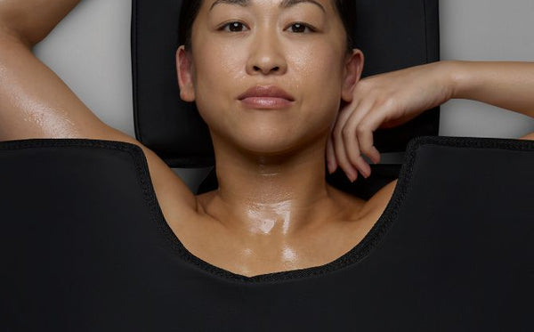 Woman using the CurrentBody Wellness Sauna Blanket