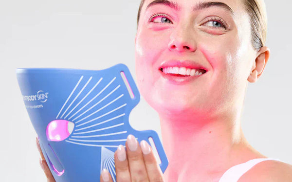 Woman holding CurrentBody Skin LED Blue Light Therapy Mask