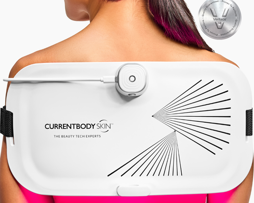 CurrentBody LED Light Therapy Panel on woman's back for pain relief and skin treatment